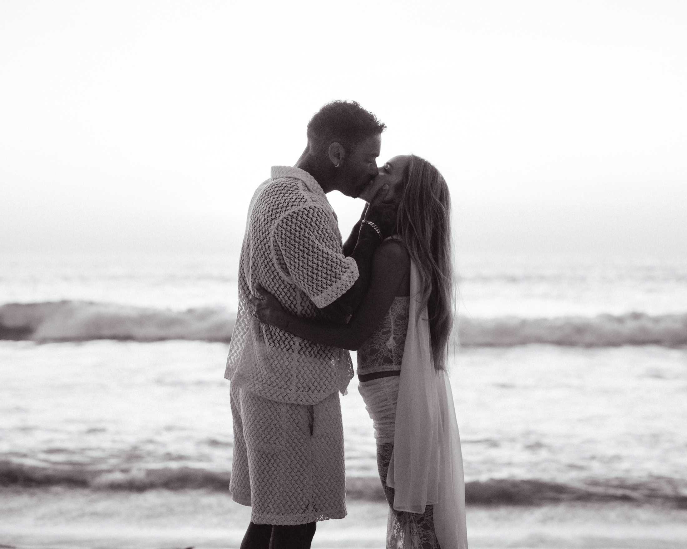 A couple at golden hour by the sea — fine-art destination wedding photography